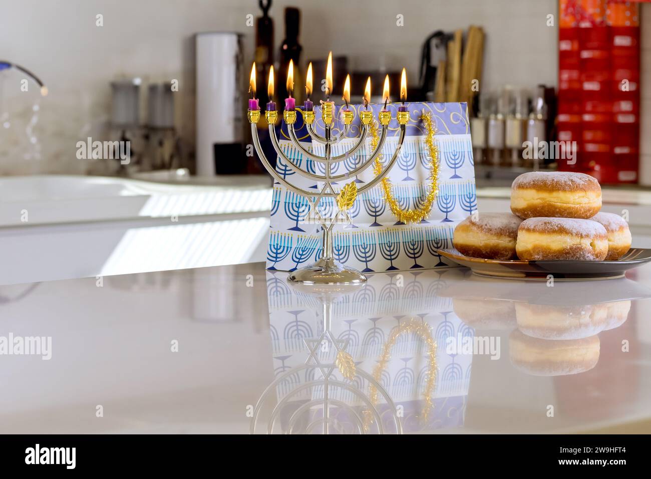 Hanukkiah Menorah candle light during traditional celebration of Jewish religion holiday Stock