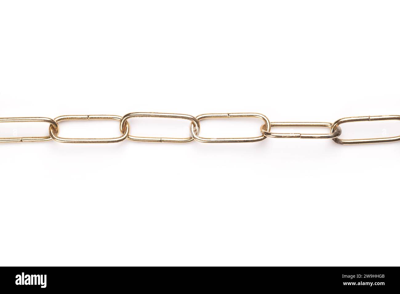 Elongated steel chain with shiny, brass plated surface, straight shaped, with rounded links. Smooth and decorative ring chain, made of round wire. Stock Photo