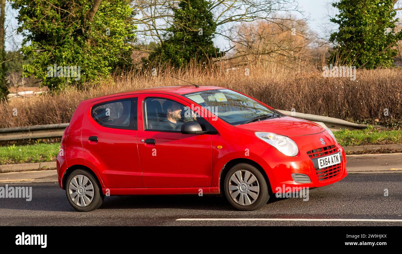Milton Keynes, UK - Dec 28th 2023: 2014 red Suzuki Alto  car driving on a British road Stock Photo