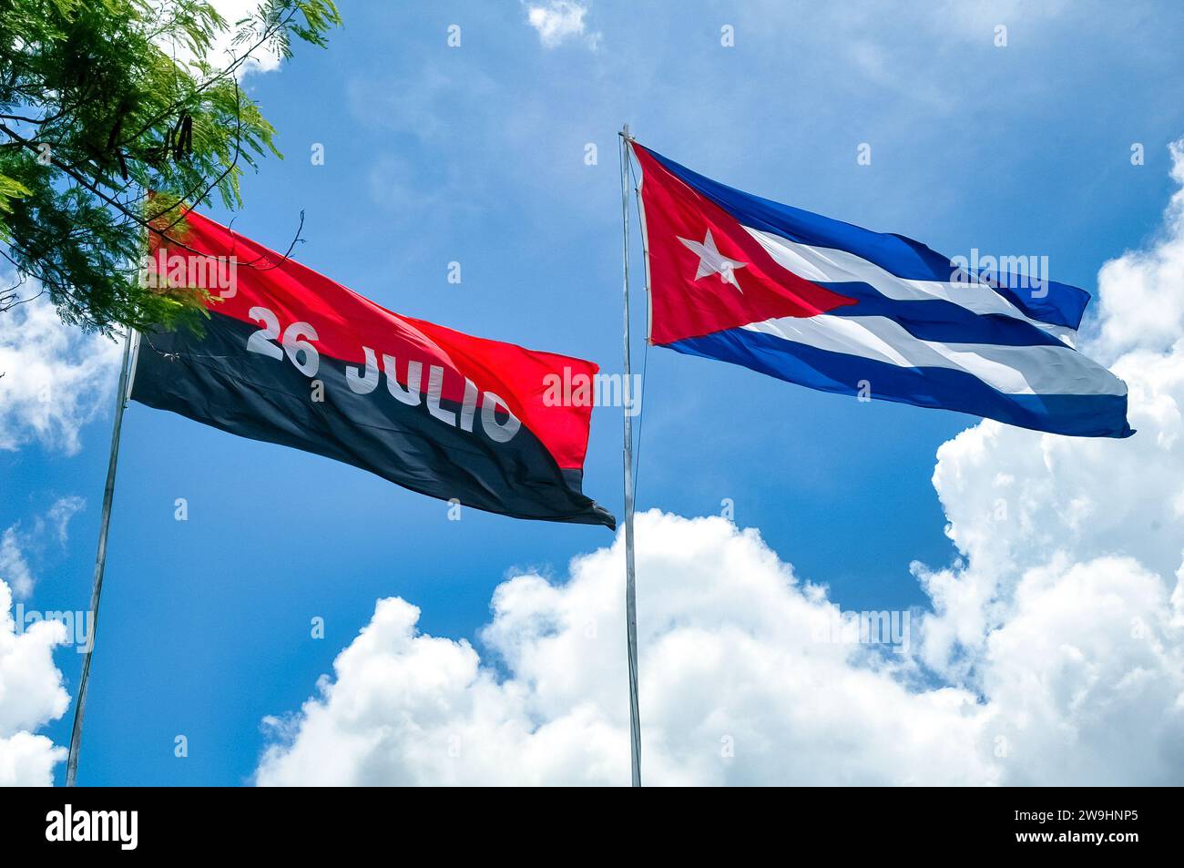 Cuban Flags waving in blue sky at the Che Guevara memorial in Loma del