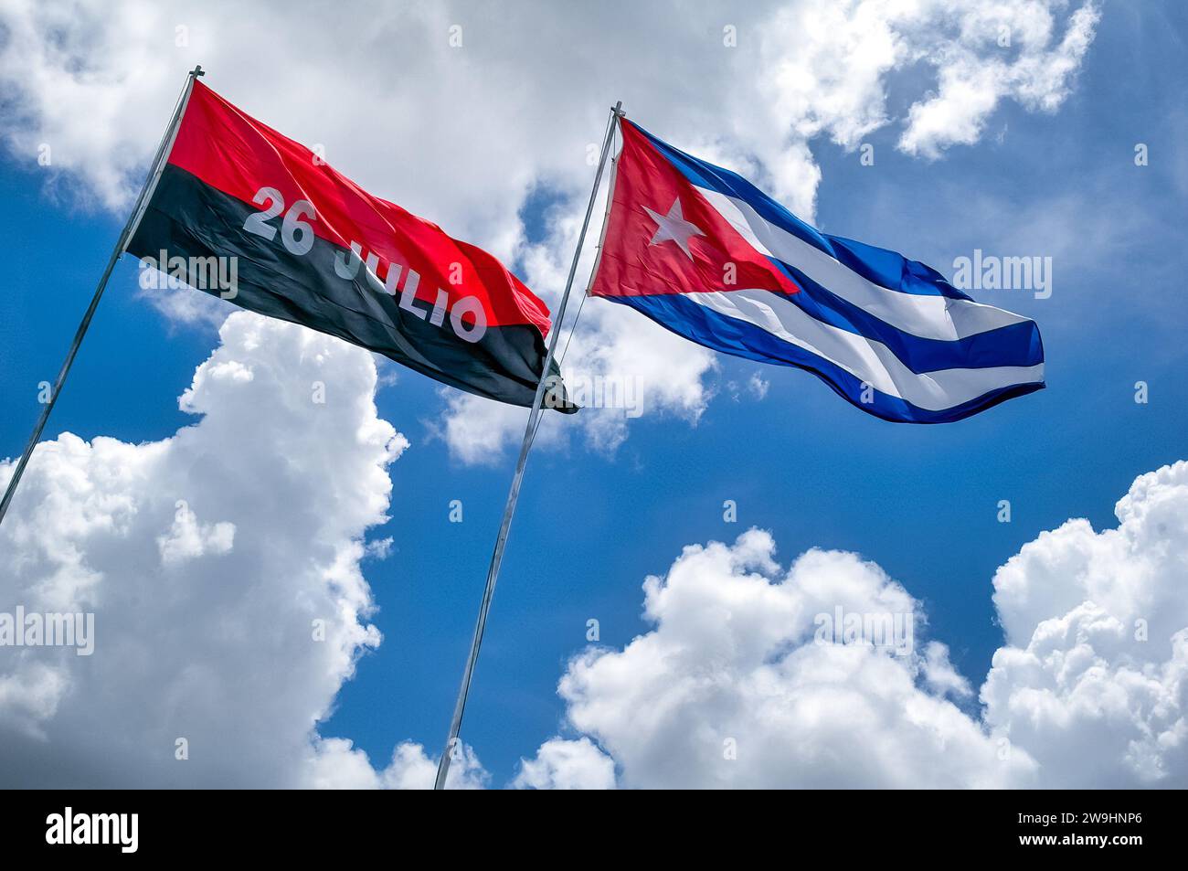 Cuban Flags waving in blue sky at the Che Guevara memorial in Loma del