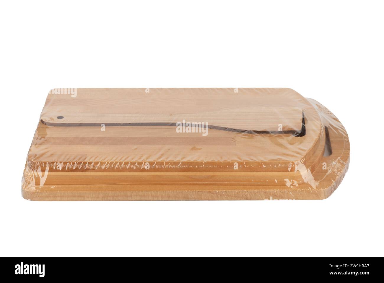 Kitchen set of cutting boards and a kitchen spatula, packed in polyethylene, on a white background. Copy space. Stock Photo