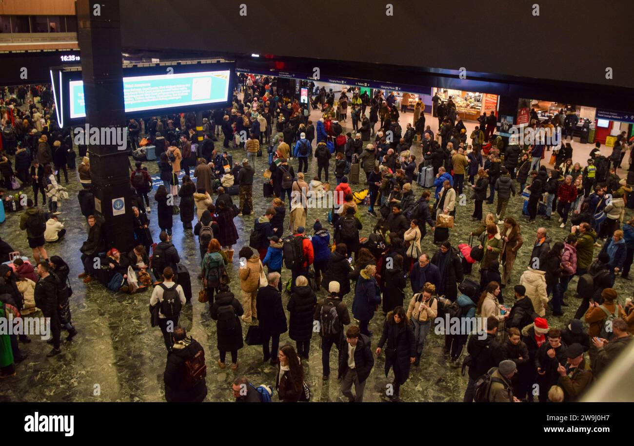 london-uk-28th-december-2023-passengers-await-information-at-euston
