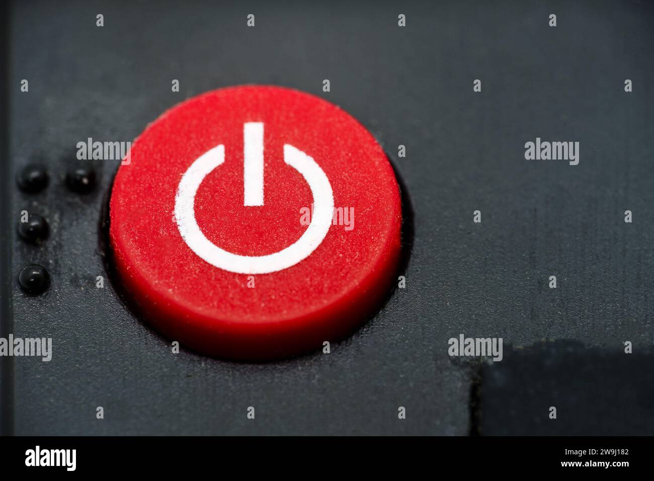 Red power button of a TV remote, close up macro. Stock Photo