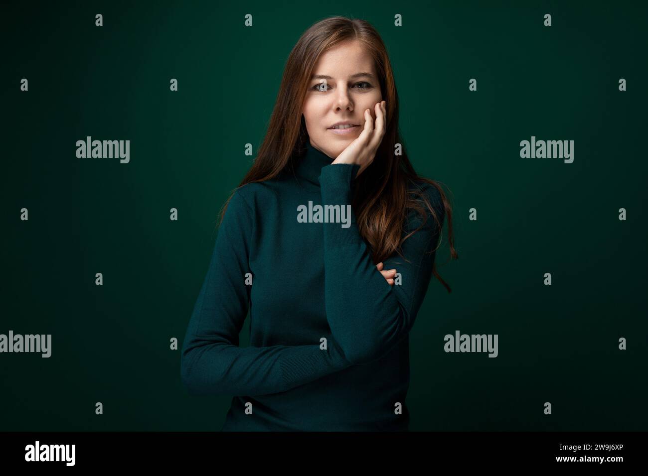 Cute young woman with brown hair wearing a green turtleneck Stock Photo ...