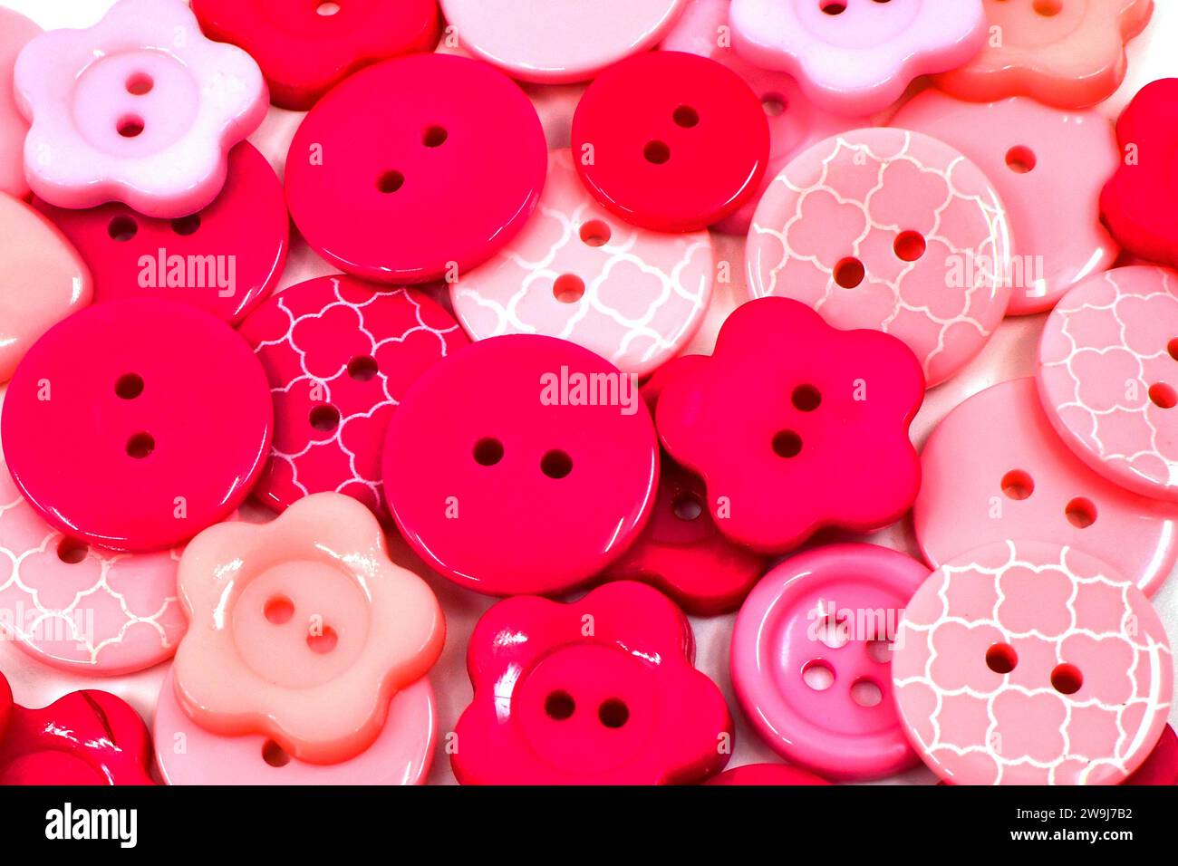 Close up view of pink and red plastic buttons. Craft concept. Backgrounds. Stock Photo