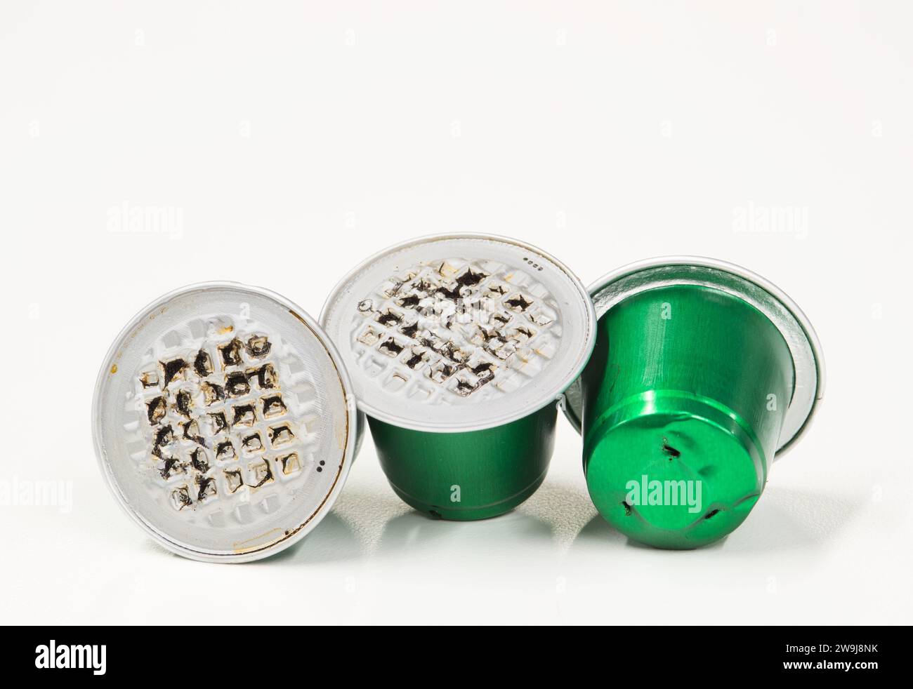 Green used plastic Espresso coffee pods single use cups, isolated on a