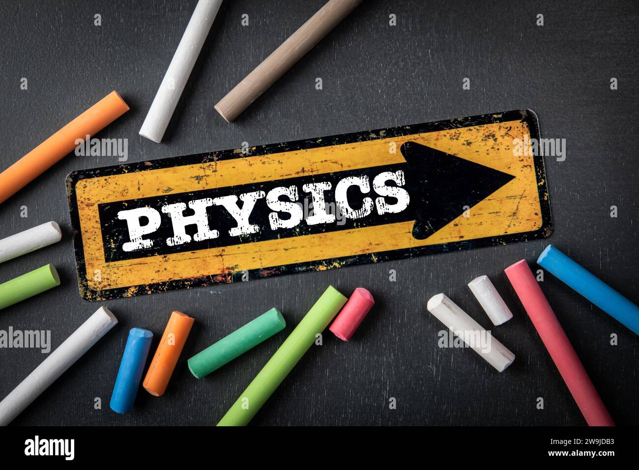 PHYSICS. Direction arrow with text on a dark chalkboard background Stock Photo Alamy