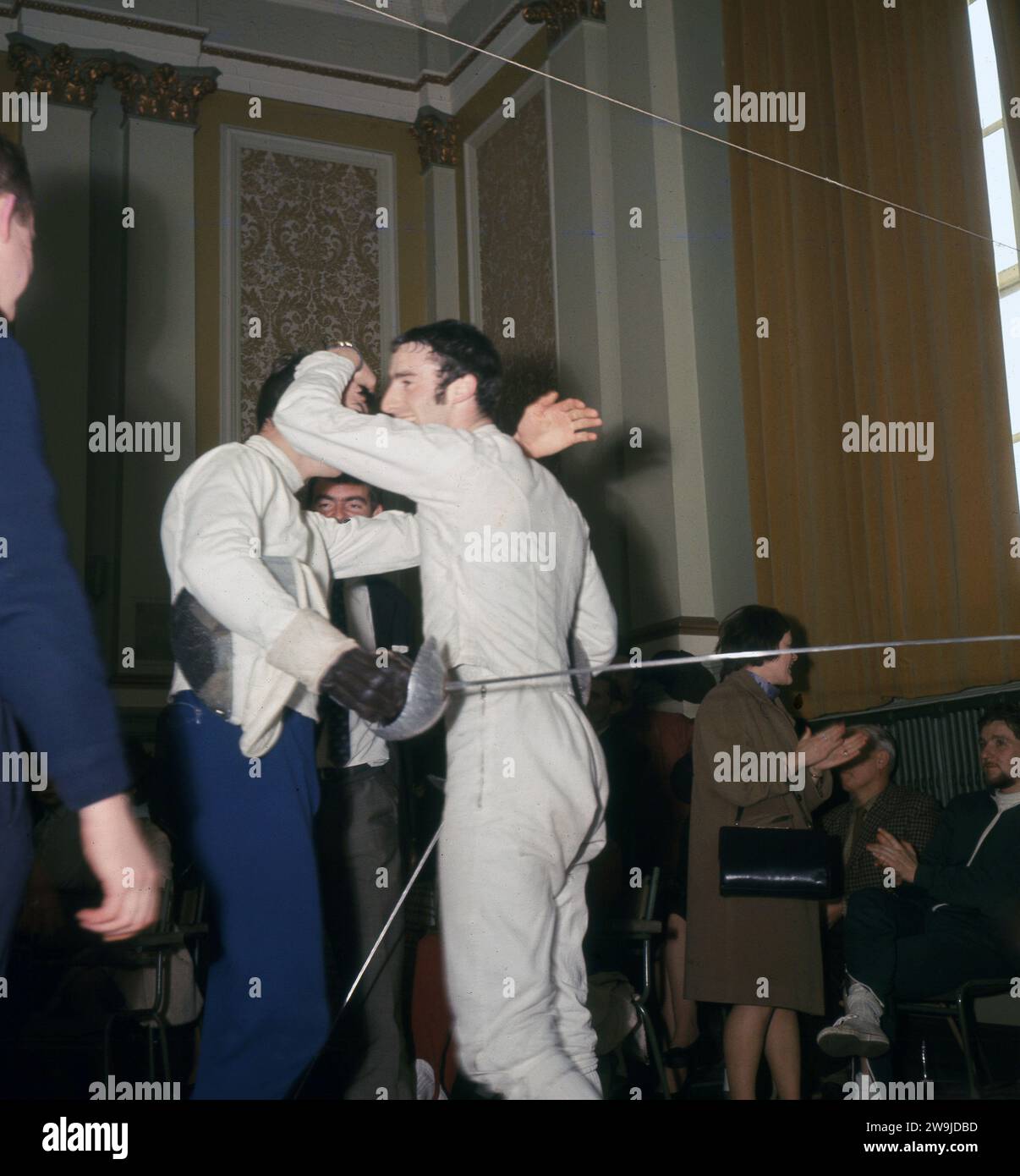 1960s, historical, good sportsmen ship, after an exhuasting contest two male fencers congratulate each other, England, UK. Stock Photo