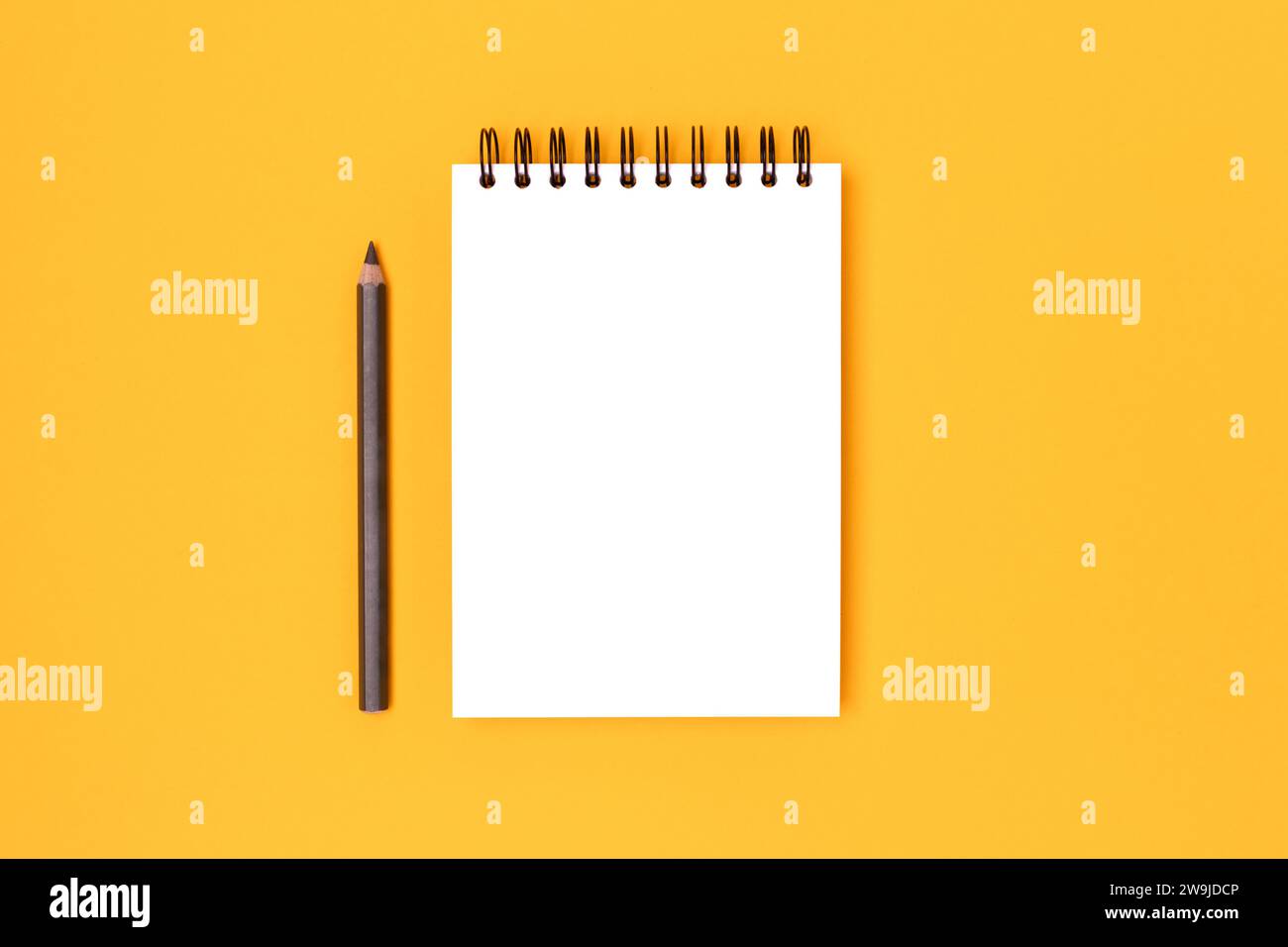 Clean notepad mockup and pencil on a yellow background. Notebook ...
