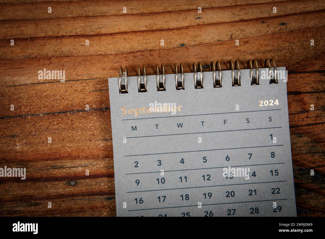 SEPTEMBER. Green cardboard calendar on a wooden texture background. Stock Photo