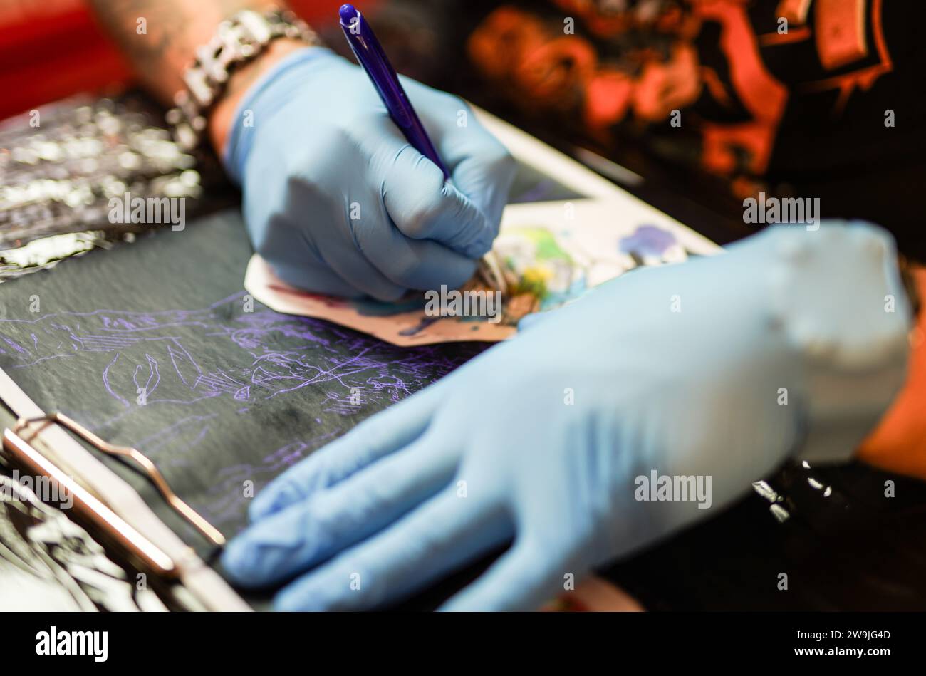 A  tattoo artist during work Stock Photo