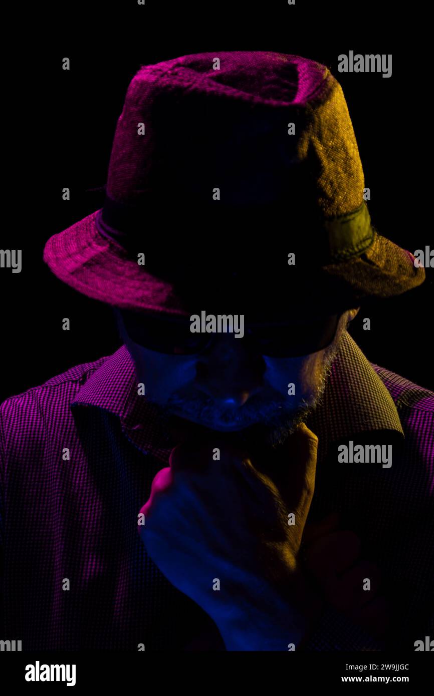 Portrait of a serious mysterious man with a beard wearing a hat and ...