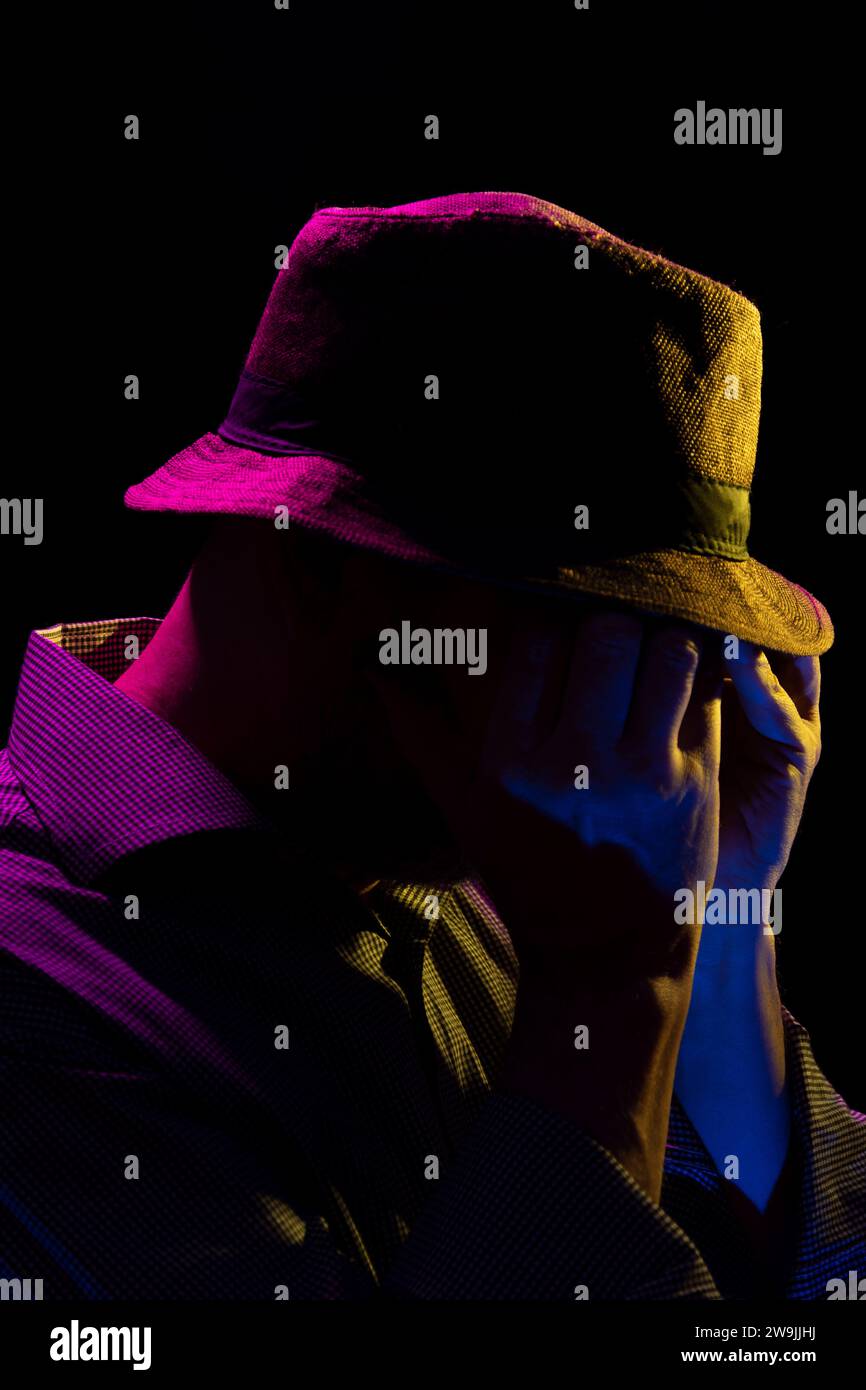Portrait of a serious mysterious man with a beard wearing a hat and ...