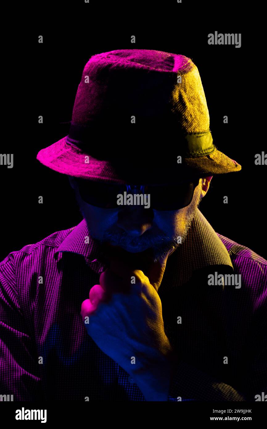 Portrait of a serious mysterious man with a beard wearing a hat and ...