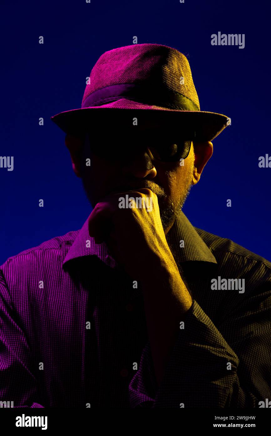 Portrait of a serious mysterious man with a beard wearing a hat and ...