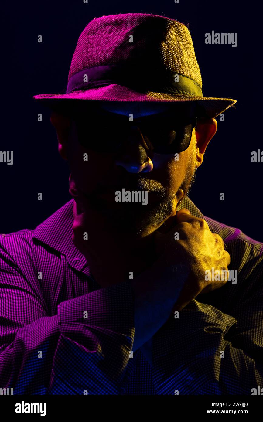 Portrait of a serious mysterious man with a beard wearing a hat and ...