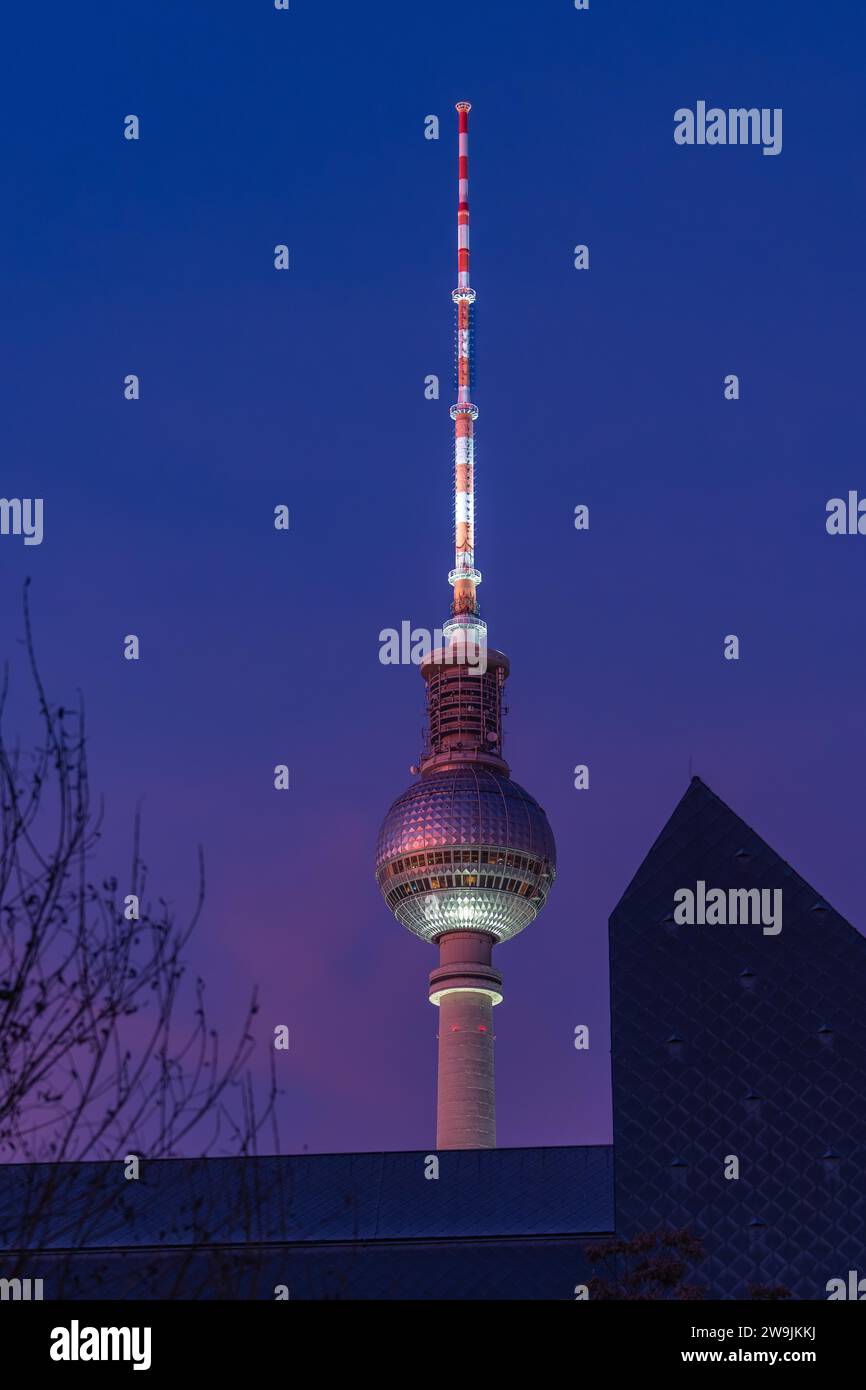 Television tower against the evening sky with illuminated antenna, Berlin, Germany Stock Photo