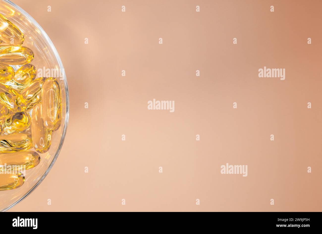 Omega 3 fish oil gel capsules on a neutral peach background. Cod liver