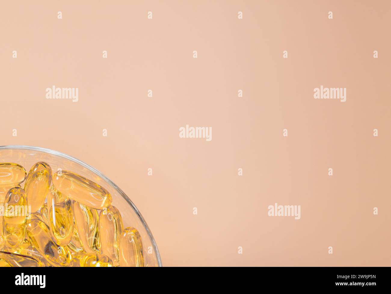 Omega 3 fish oil gel capsules on a neutral peach background. Cod liver