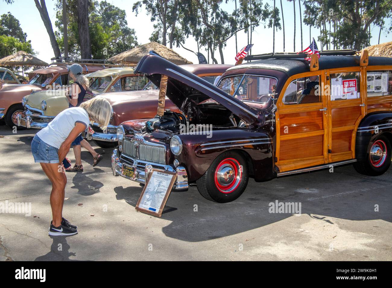 A 1946 Mercury Model 114 'woodie' station wagon is on display at a vintage car rally in Dana Point, CA. Note 'Surfer Gal' vanity license plate. Stock Photo