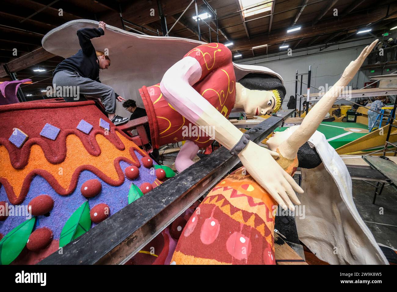 Volunteers work on a float for the 135th Rose Parade in Pasadena