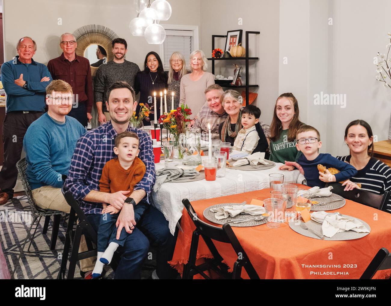 Interior group portrait of extended family gathered for Thanksgiving Day meal Stock Photo