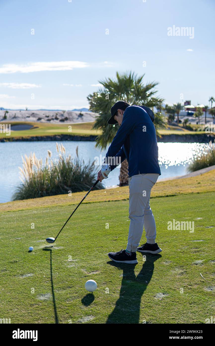Golfer swings club in Bali Hai Golf course in Las vegas Nevada Stock Photo Alamy