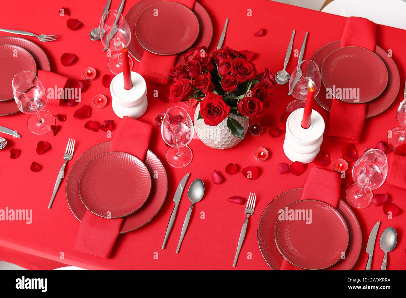 Dining table with setting, candles and red roses for Valentine's Day ...