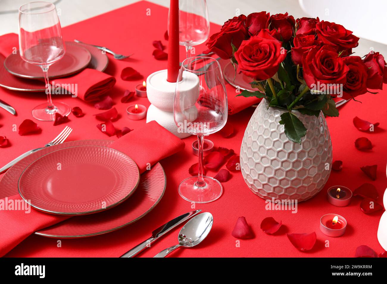 Dining table with setting, candles and red roses for Valentine's Day ...