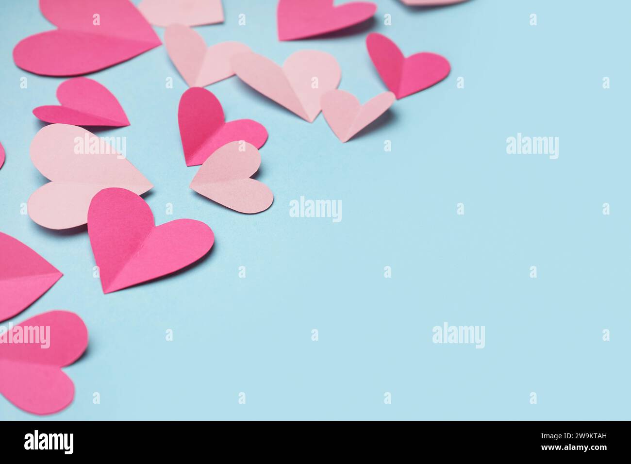 Pink paper hearts on blue background. Valentine's Day celebration Stock ...