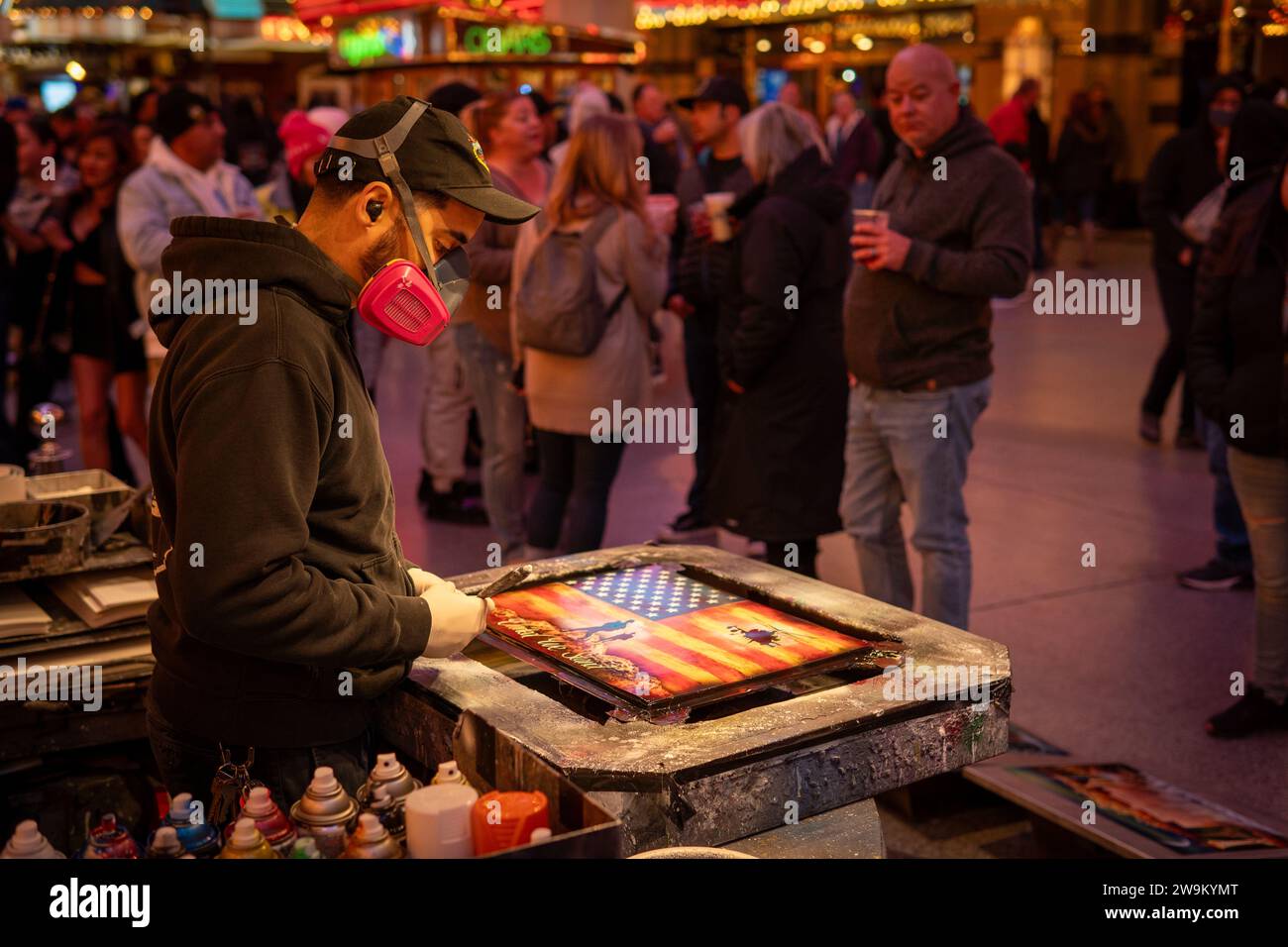 Spray painter creating outdoor street art in Fremont street in Las