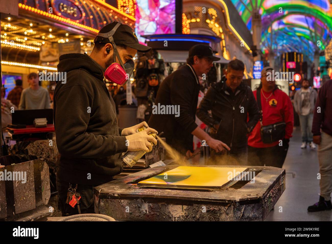 Spray painter creating outdoor street art in Fremont street in Las