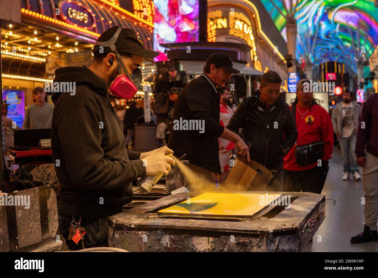 Spray painter creating outdoor street art in Fremont street in Las