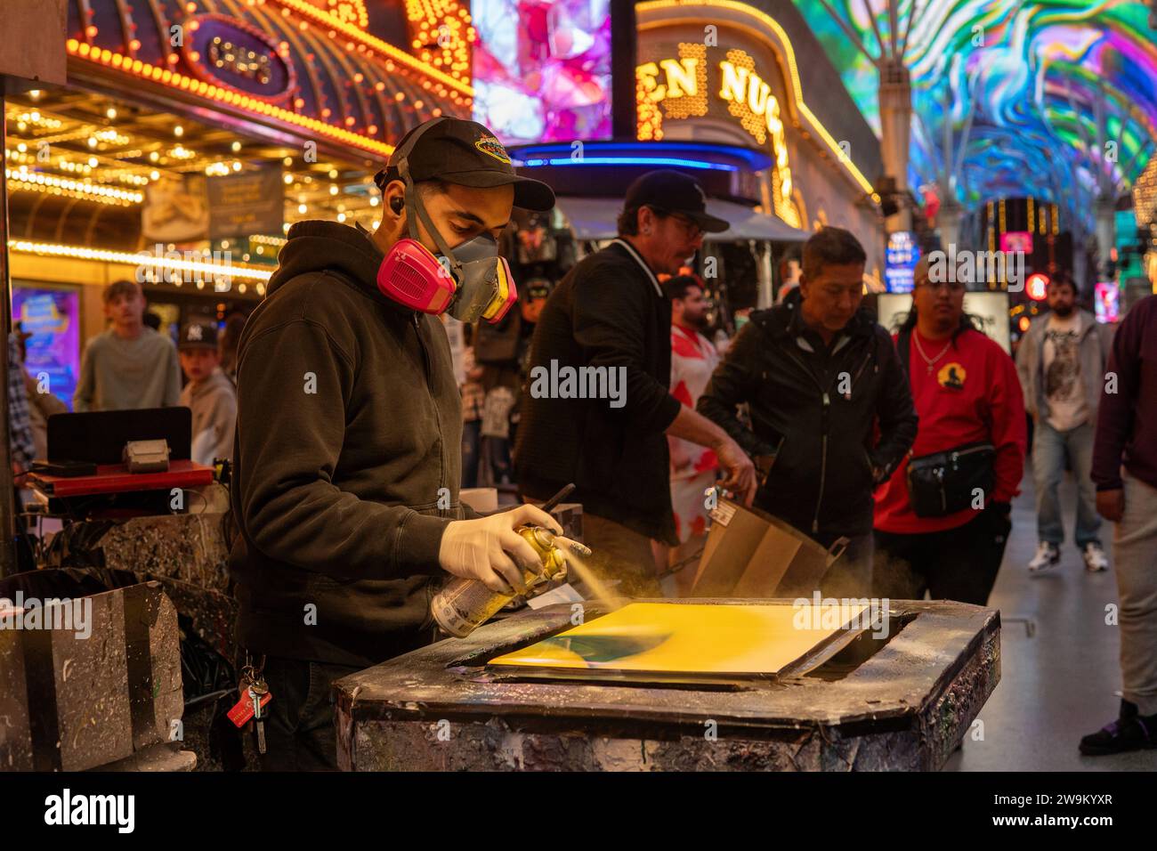 Spray painter creating outdoor street art in Fremont street in Las