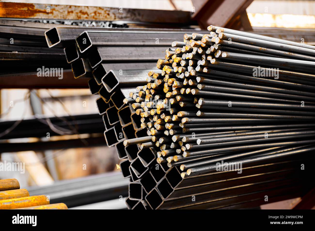 Square tubing on blurred background in cold warehouse Stock Photo - Alamy