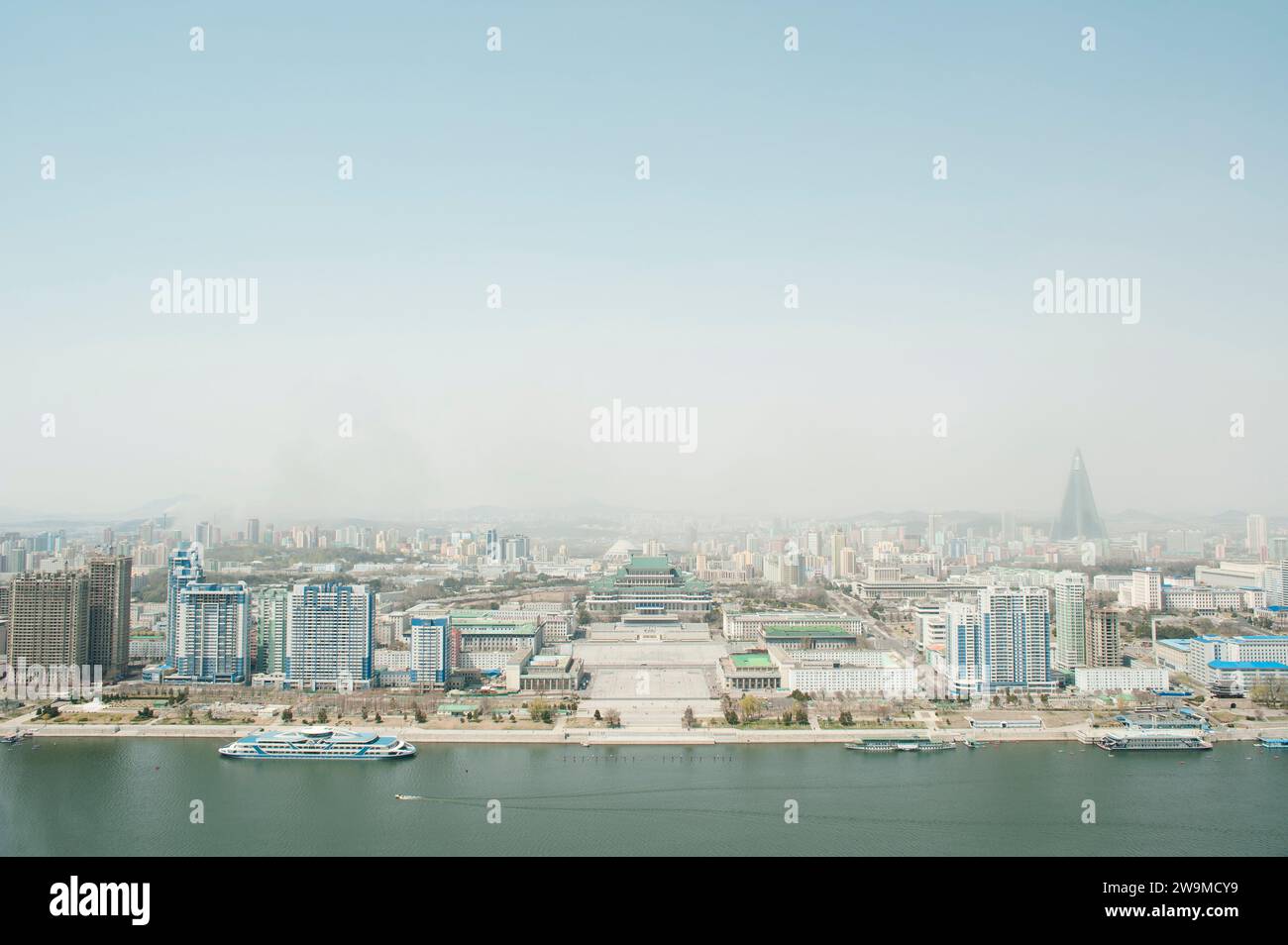 The view of downtown Pyongyang in North Korea from the top of the Juche Tower including the Taedong River, Kim Il Sung Square and the Ryugyong Hotel. Stock Photo