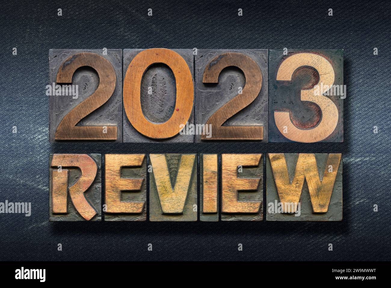 review 2023 phrase made from wooden letterpress on dark jeans background Stock Photo