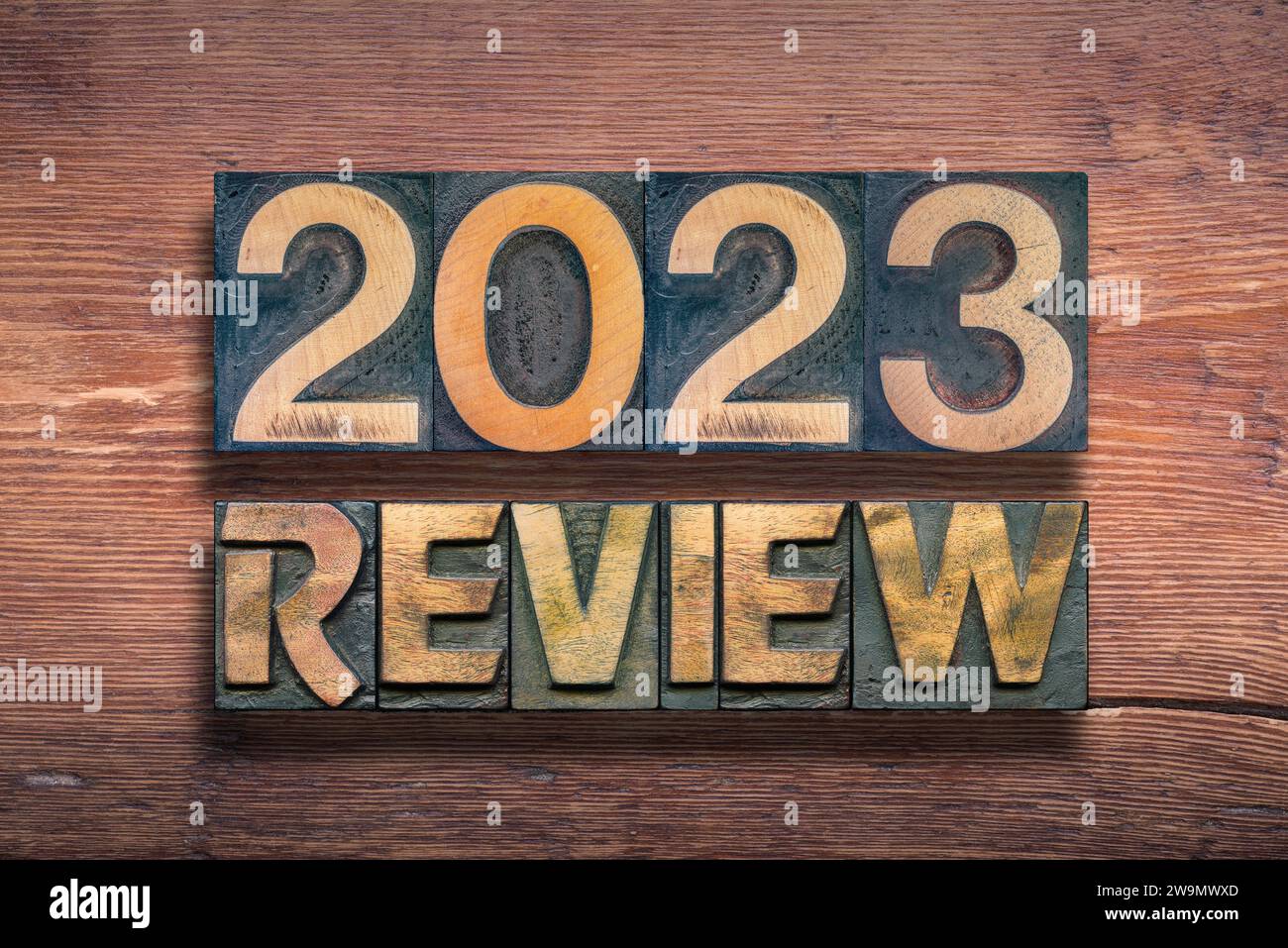 review 2023 combined from vintage letterpress on  varnished wooden surface Stock Photo
