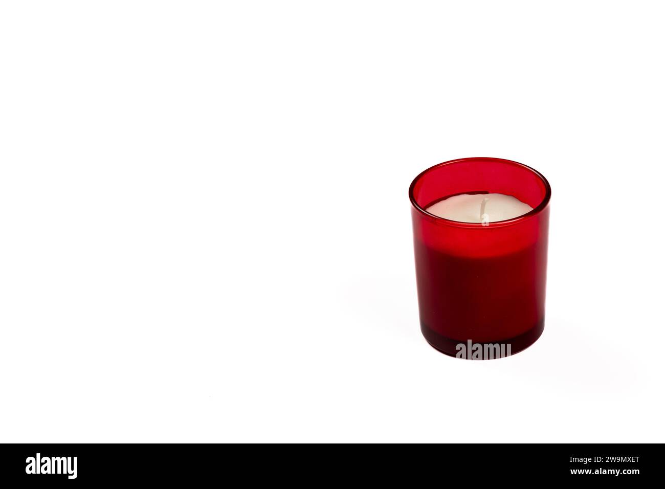 Red Glass Candle on White Background - Serene Non-Lit Decor for Home Ambiance Stock Photo
