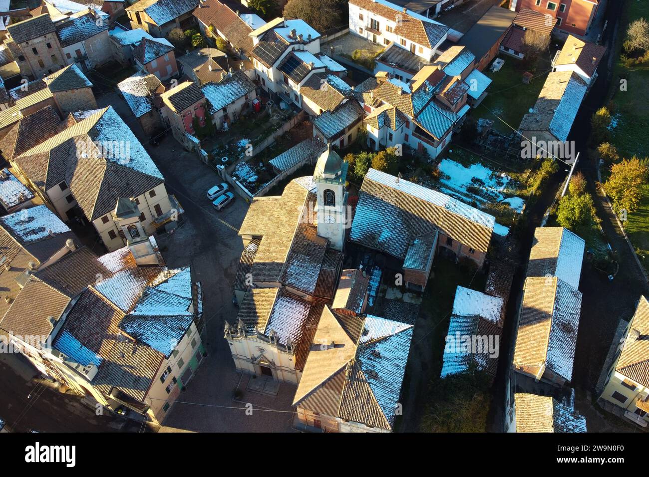 Aerial view of church and village rooftops in winter, Carezzano, Alexandria, Piedmont, Italy Stock Photo