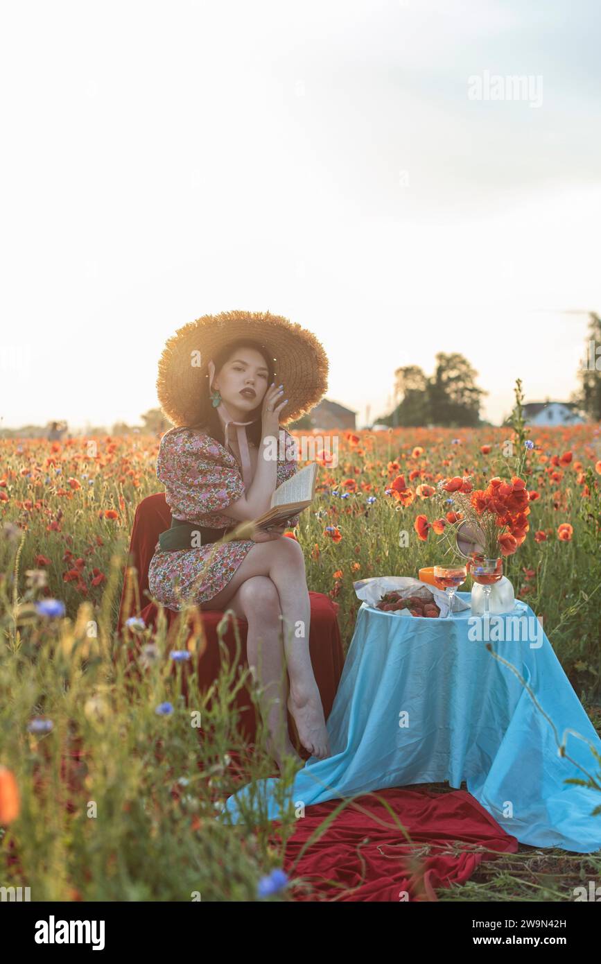 A young girl in a flowering poppy field Stock Photo - Alamy