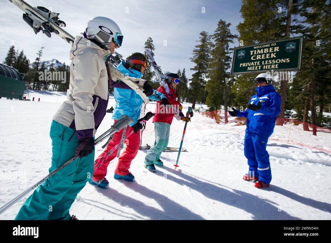 A group of women gather around and listen to their ski instructor in the winter at Kirkwood Mountain Resort in Kirkwood, California. Stock Photo