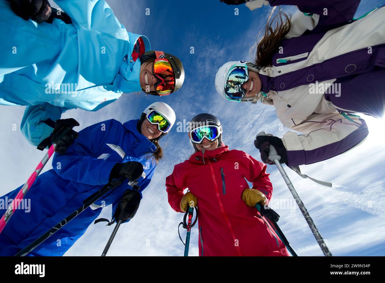 A group of female skiers gather around and smile with their ski instructor in the winter at Kirkwood Mountain Resort in Kirkwood, California. Stock Photo