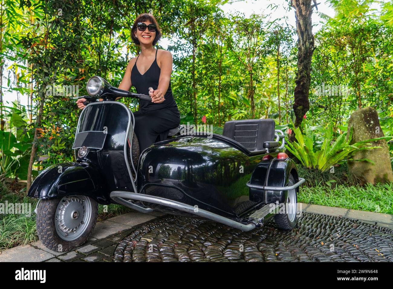 beautiful woman sitting on sidecar scooter Stock Photo