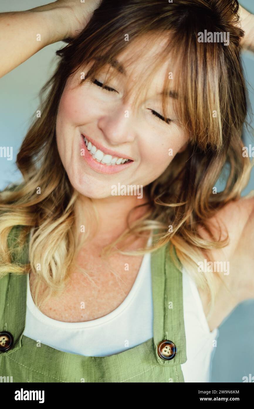 Close Up of Woman smiling in green overalls Stock Photo