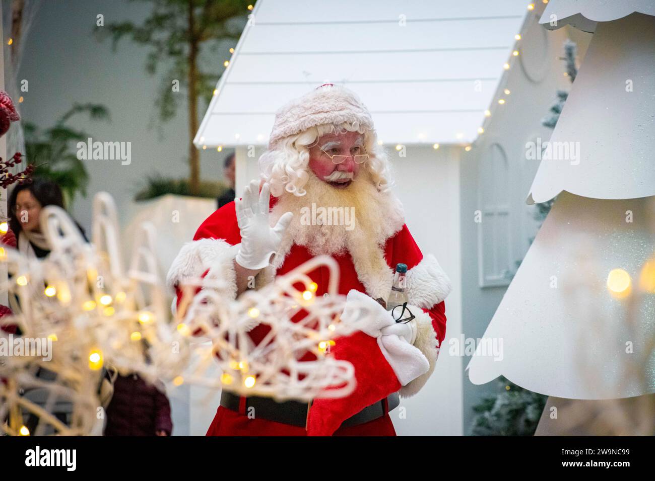 Father Christmas welcomes children at Christmas time Stock Photo