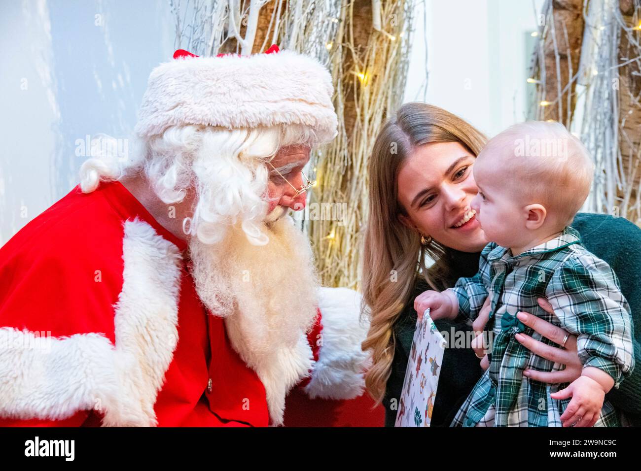 A mother and her daughter meet Santa Claus at Christmas time Stock Photo