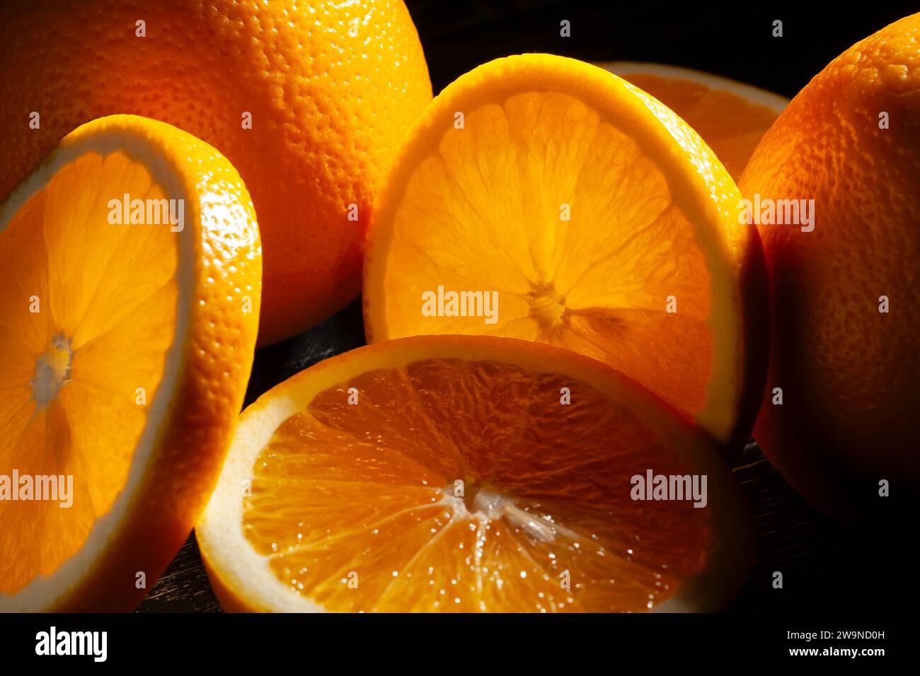 sliced orange fruit on black background Stock Photo