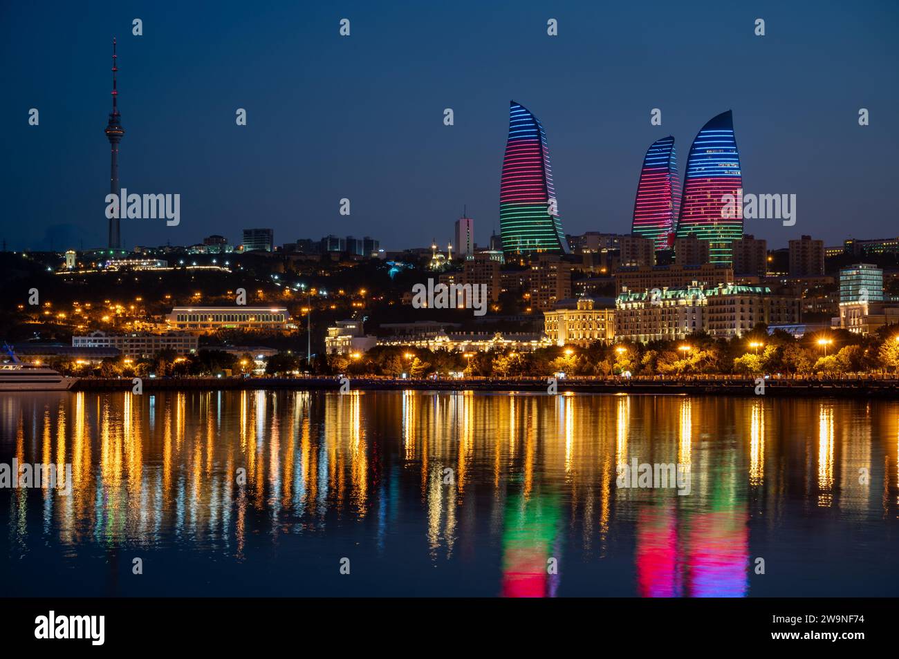Night view of the the skyline of Baku, capital city of Azerbaijan with reflection of the Flame Towers in the waters of the Caspian Sea. Stock Photo